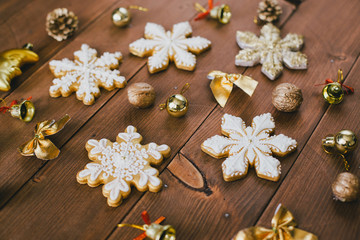 Christmas cookies with frosting on a wooden table.