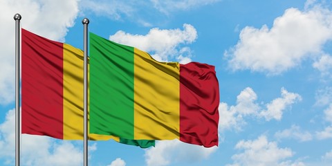 Guinea and Mali flag waving in the wind against white cloudy blue sky together. Diplomacy concept,...