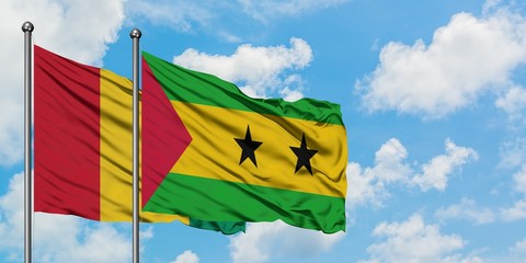 Guinea and Sao Tome And Principe flag waving in the wind against white cloudy blue sky together. Diplomacy concept, international relations.