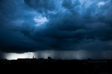 Fototapeta na wymiar Storm cloud with heavy rain, lightning over city