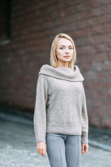 Woman in jacket emotional portrait. Beautiful smiling girl in town.