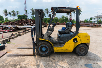 Yellow Forklift in the factory outdoor area.