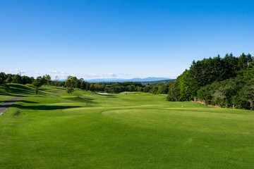 Fototapeta na wymiar View of Golf Course with teeing area. Golf course with a rich green turf beautiful scenery.