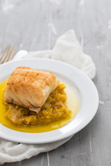 cod fish with sweet potato and olive oil on white dish