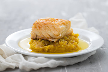 cod fish with sweet potato and olive oil on white dish