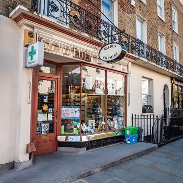 Traditional English Chemist Shop. The display window and façade to a small business London shop on the streets of Kensington and Chelsea.