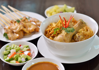 Khao Soi Chicken, northern Thai noodle dish with chicken and coconut curry soup, shown with crispy noodles and other vegetables