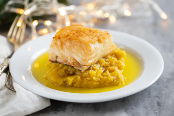 cod fish with sweet potato and olive oil on white dish