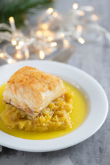 cod fish with sweet potato and olive oil on white dish