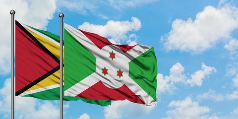 Guyana and Burundi flag waving in the wind against white cloudy blue sky together. Diplomacy concept, international relations.