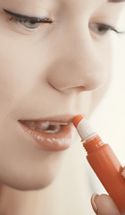 makeup lipstick, a young girl paints her lips, the concept of glamor, fashion, beauty, cosmetics