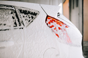White car at the sink in the foam