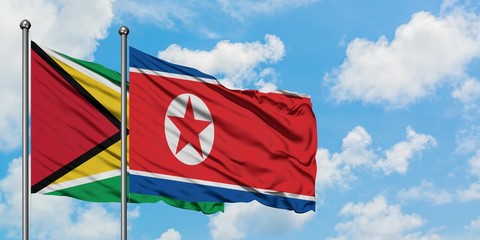 Guyana and North Korea flag waving in the wind against white cloudy blue sky together. Diplomacy concept, international relations.