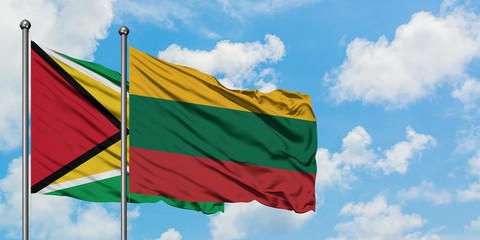 Guyana and Lithuania flag waving in the wind against white cloudy blue sky together. Diplomacy concept, international relations.