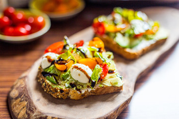 Toasts with Cherry Tomatoes, Mozzarella Cheese, Basil Leaves and Balsamic Sauce