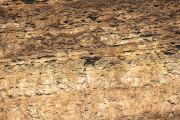 high stone rock against the blue sky