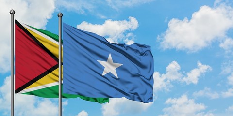 Guyana and Somalia flag waving in the wind against white cloudy blue sky together. Diplomacy concept, international relations.