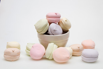 Sweet tasty marshmallows in a plate on a white background.