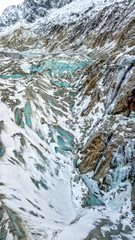 Aerial drone view of tourists walking down to Grotte de Glace, glacier in Montenvers, near...