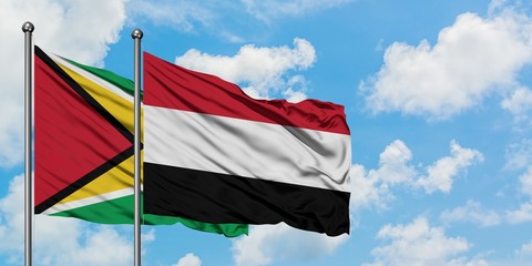 Guyana and Yemen flag waving in the wind against white cloudy blue sky together. Diplomacy concept, international relations.