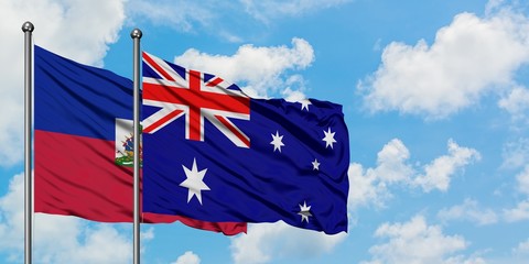 Haiti and Australia flag waving in the wind against white cloudy blue sky together. Diplomacy concept, international relations.