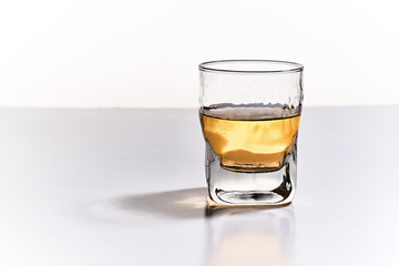 Front and horizontal view of insulated whiskey glass on white background