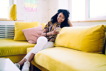 Happy female using smartphone at home