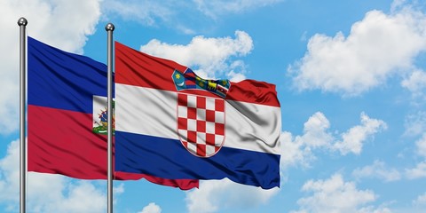 Haiti and Croatia flag waving in the wind against white cloudy blue sky together. Diplomacy concept, international relations.
