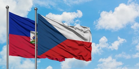 Haiti and Czech Republic flag waving in the wind against white cloudy blue sky together. Diplomacy concept, international relations.