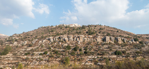 View from the highway number 5 to the Palestinian village Ayn as Sararah located on a hill in Samaria region in Benjamin district, Israel - obrazy, fototapety, plakaty
