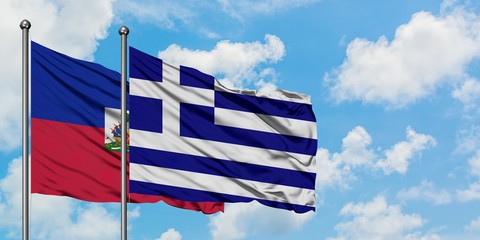 Haiti and Greece flag waving in the wind against white cloudy blue sky together. Diplomacy concept, international relations.