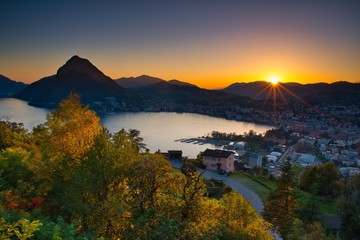 Stadtansicht von Lugano mit See und Berg San Salvatore bei Sonnenuntergang