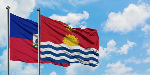 Haiti and Kiribati flag waving in the wind against white cloudy blue sky together. Diplomacy concept, international relations.