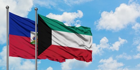 Haiti and Kuwait flag waving in the wind against white cloudy blue sky together. Diplomacy concept, international relations.