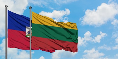 Haiti and Lithuania flag waving in the wind against white cloudy blue sky together. Diplomacy concept, international relations.