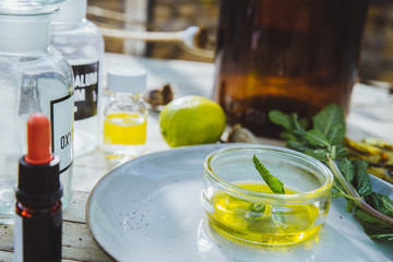 Modern apothecary on a naural wooden desk with herbs and wildflowers showing a minimalist organic lyfestyle.