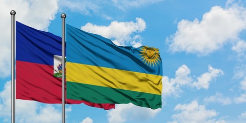 Haiti and Rwanda flag waving in the wind against white cloudy blue sky together. Diplomacy concept, international relations.