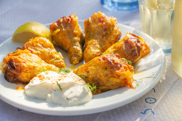 Greek traditional gemista, stuffed tomatoes and peppers on a white plate served in taverna with retsina, Greece