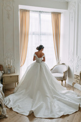 Fototapeta premium European-style wedding at the hotel. Bride in a white dress in the interior Studio.
