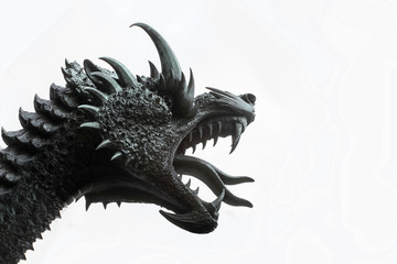 sculpture: dragon head with open mouth against the sky. The dragon struck by St. George.