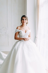 Fototapeta premium European-style wedding at the hotel. Bride in a white dress in the interior Studio.