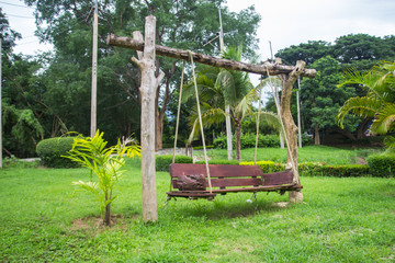Fototapeta na wymiar Swings made ​​of wood, in the park.