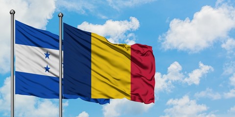 Honduras and Chad flag waving in the wind against white cloudy blue sky together. Diplomacy...