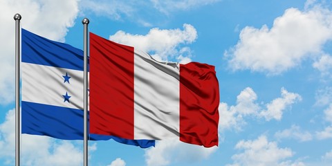 Honduras and Peru flag waving in the wind against white cloudy blue sky together. Diplomacy concept, international relations.
