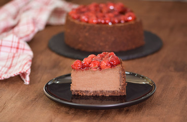 Delicious Piece Of Chocolate Cheesecake with cherry.