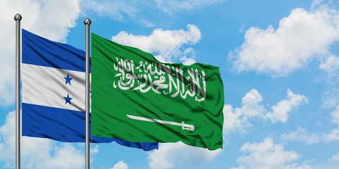 Honduras and Saudi Arabia flag waving in the wind against white cloudy blue sky together. Diplomacy concept, international relations.