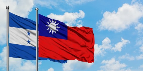 Honduras and Taiwan flag waving in the wind against white cloudy blue sky together. Diplomacy concept, international relations.