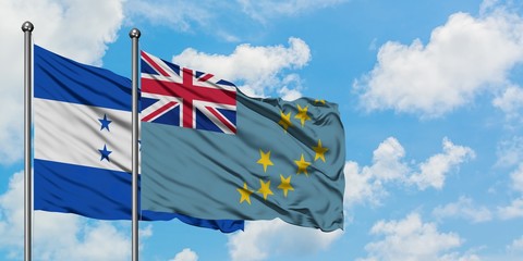 Honduras and Tuvalu flag waving in the wind against white cloudy blue sky together. Diplomacy...