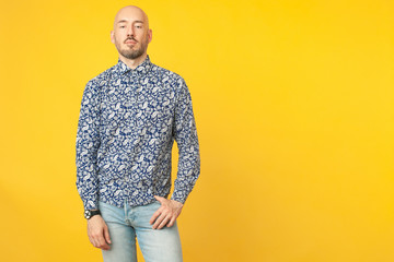 Fabulous at any age. Portrait of 40-year-old vegan man standing over light yellow background in...