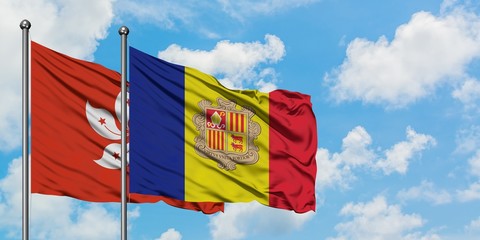 Hong Kong and Andorra flag waving in the wind against white cloudy blue sky together. Diplomacy...